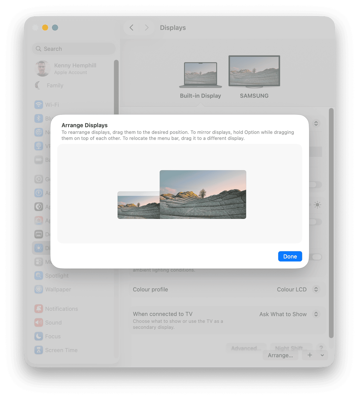macOS Arrange Displays dialog for repositioning Mac Dock between built-in and external Samsung monitor